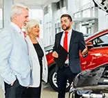 A car salesman shows a car