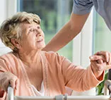 A senior with a walker getting care