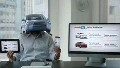 A guy with a car for a head shows Edmunds on a phone tablet and pc