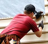 A siding expert installing siding