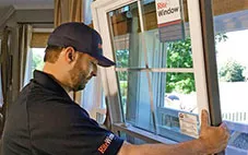 A window installer installs a window