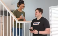 A woman speaks with a mover about the move